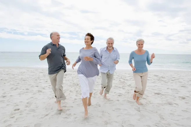 Four elders running on the beach. alert1 medical alert system Four elders running on the beach. alert1 medical alert system